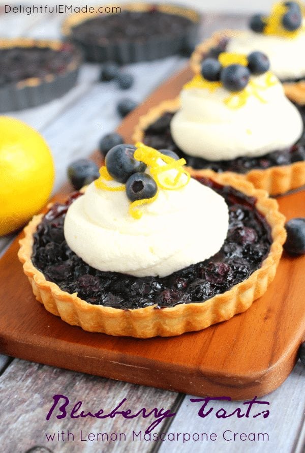 These Blueberry Tarts are as easy as pie, and taste even better! Topped with a delicious Lemon Mascarpone Cream, these mini-tarts are the perfect dessert for any occasion!
