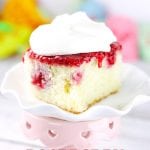 Fresh Raspberry Poke Cake Dessert Recipe! Perfect for holidays and birthdays with light frosting that won't weigh you down. Recipe on www.embellishmints.com