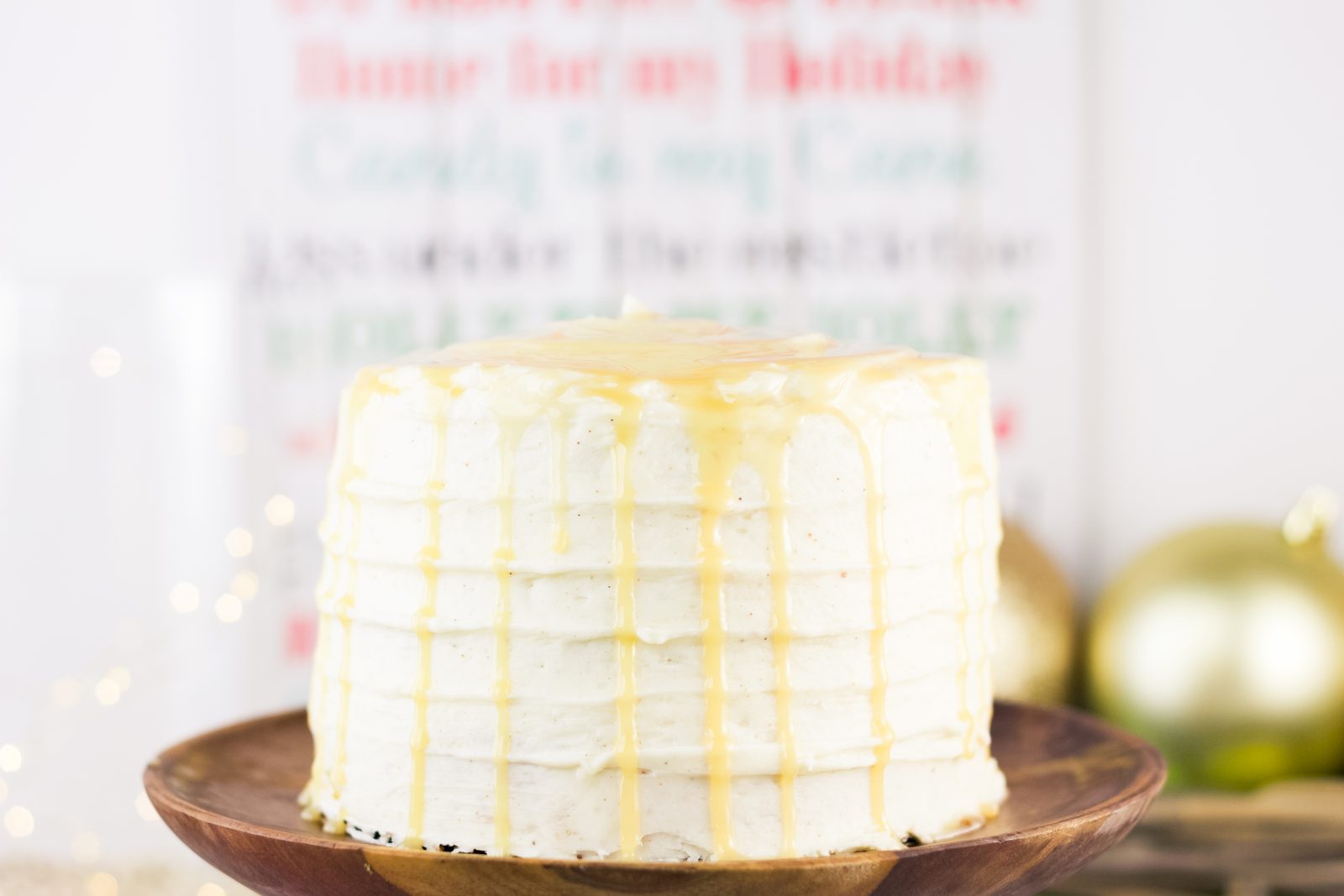 This eggnog cake recipe is everything you need to get into the holiday spirit! Topped with a rum simple syrup and cream cheese frosting, it's a must try! Find the recipe on www.Embellishmints.com
